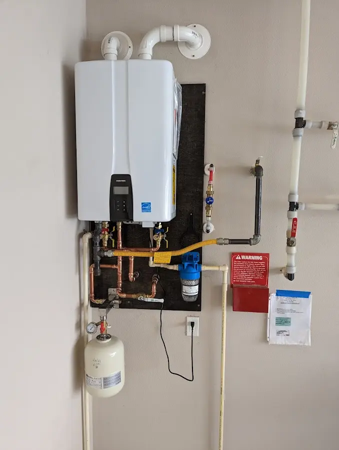 Professional plumber installing copper piping in a Rupert home